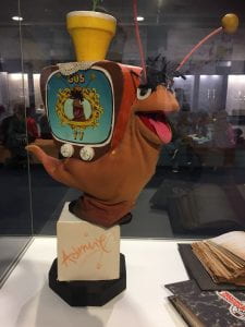 Gus the Snail puppet with a Television on his back instead of a shell.